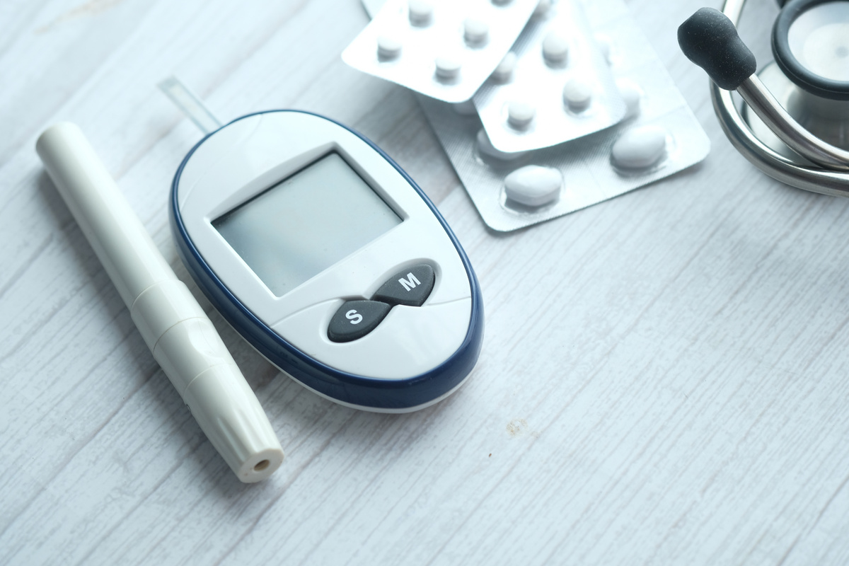 Close up of Diabetic Measurement Tools and Pills on Color Background